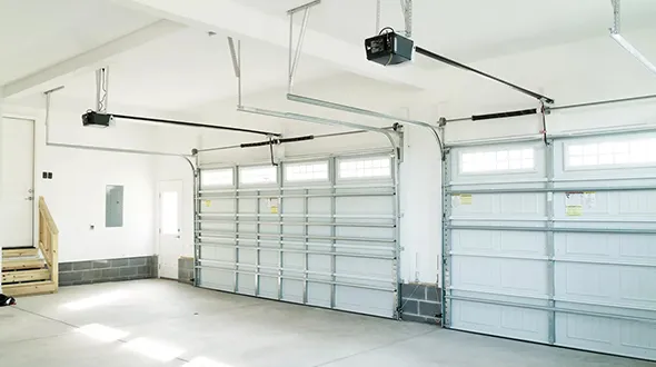 Interior view of a modern garage with multiple garage doors and a clean, well-lit workspace.