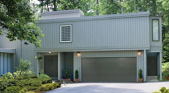 Image of a residential house with a garage door, highlighting expert installation and customer satisfaction.