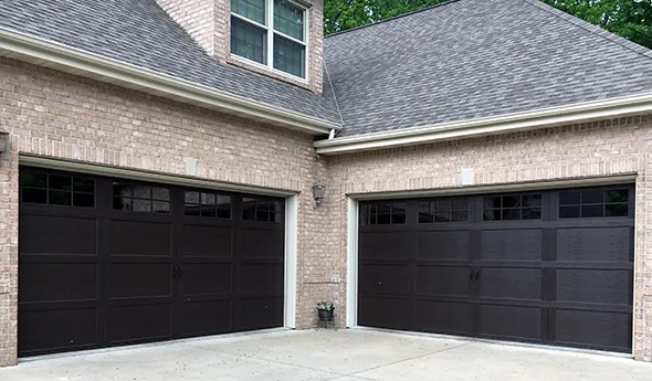 A residential house with two modern garage doors.