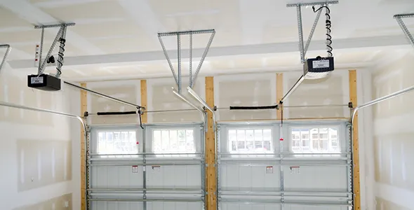 Image of a garage interior in San Marcos, TX, with installed garage door openers, highlighting local expertise and service.