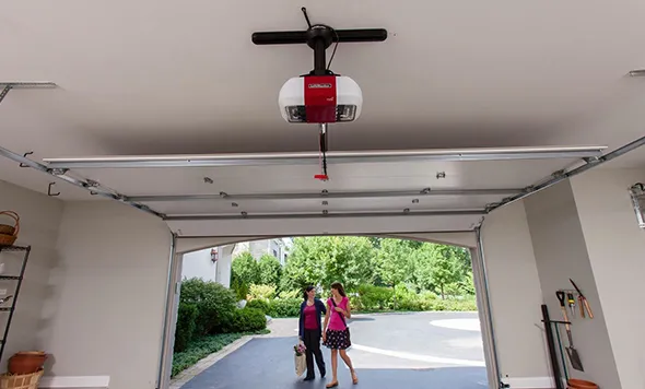 A family walking under a garage door with an installed opener, emphasizing safety and convenience.