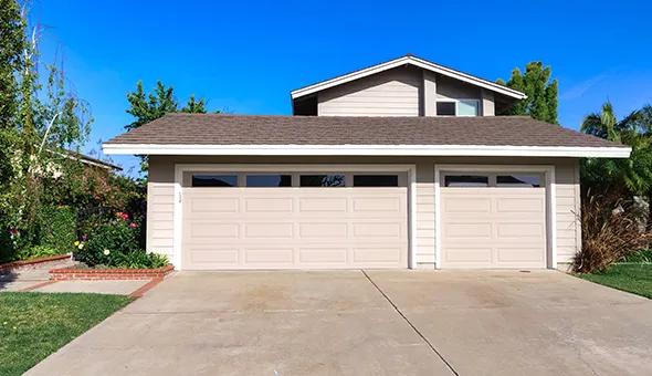 A house with a single garage door in a residential neighborhood.